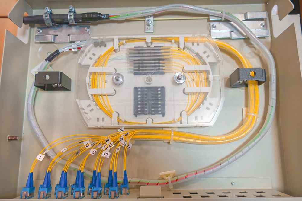 bring feeder cable from the entrance and strip the sheath, fix the strength member with cable fixtures and clamps, bring the bare fibers into the odf, and protect with sprial tube